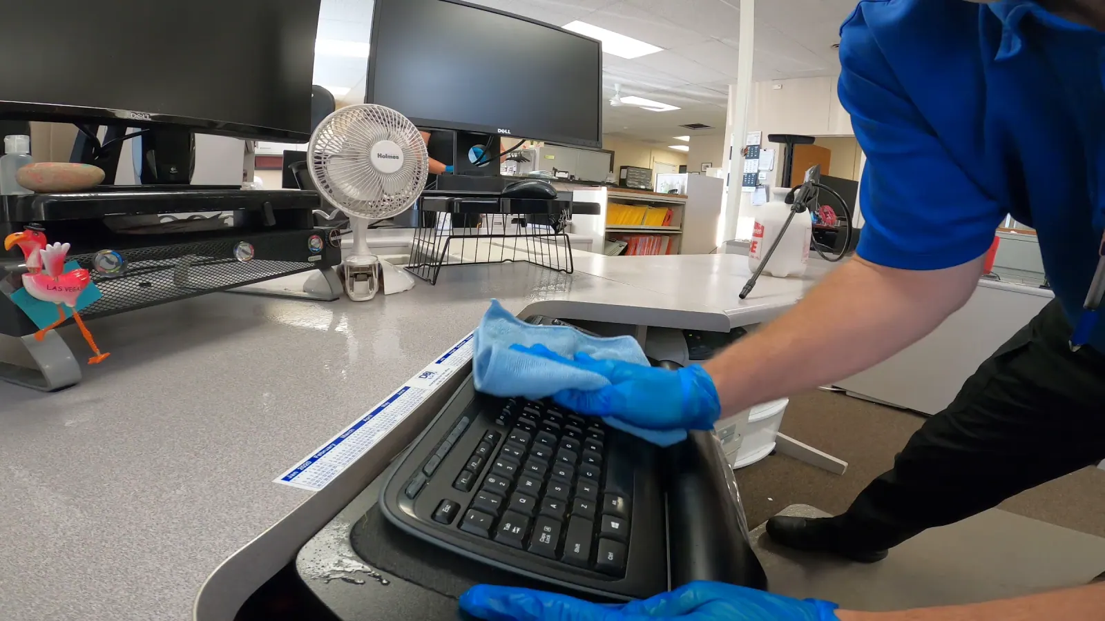 Technician detail-cleaning a Chicago office workstation
